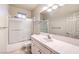 Bathroom with a shower-tub combo, vanity with a large mirror, and tile floors at 10300 Wellside Hill Ave, Las Vegas, NV 89145