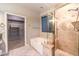 Bathroom featuring a soaking tub, glass enclosed shower, and walk-in closet at 10300 Wellside Hill Ave, Las Vegas, NV 89145