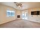 Bright bedroom with a ceiling fan, fireplace, and outdoor access; television mounted on the wall at 10300 Wellside Hill Ave, Las Vegas, NV 89145