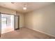 Bedroom with neutral carpet, a ceiling fan, and access to the hallway at 10300 Wellside Hill Ave, Las Vegas, NV 89145