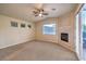 Spacious bedroom featuring a ceiling fan, fireplace, and access to an outdoor patio at 10300 Wellside Hill Ave, Las Vegas, NV 89145