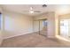 Bedroom with large windows, sliding door closet, and access to the bathroom at 10300 Wellside Hill Ave, Las Vegas, NV 89145