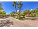 Scarlett Canyon gated community entrance with lush greenery and brick-paved streets at 10300 Wellside Hill Ave, Las Vegas, NV 89145