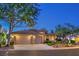 A single-story home is showcased with a three-car garage, desert landscaping, and a neutral stucco exterior at 10300 Wellside Hill Ave, Las Vegas, NV 89145