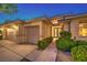 The neutral stucco home with a three-car garage is enhanced by manicured shrubs at 10300 Wellside Hill Ave, Las Vegas, NV 89145