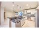 Contemporary kitchen boasts granite countertops and island sink at 10300 Wellside Hill Ave, Las Vegas, NV 89145