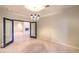 A living room boasts a tile floor, black french doors, and an open concept at 10300 Wellside Hill Ave, Las Vegas, NV 89145