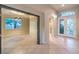 A spacious living room features a tile floor, a unique light fixture, and an open concept at 10300 Wellside Hill Ave, Las Vegas, NV 89145