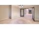 A spacious living room is enhanced with tile floors, unique lighting, and black french doors at 10300 Wellside Hill Ave, Las Vegas, NV 89145