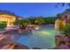 Beautiful backyard pool area with lush landscaping and a rock waterfall feature at 10300 Wellside Hill Ave, Las Vegas, NV 89145