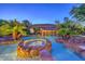 Resort-style backyard featuring a custom pool, spa and rock waterfall at 10300 Wellside Hill Ave, Las Vegas, NV 89145