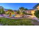Lush backyard with pool, waterfall, and mature landscaping features at 10300 Wellside Hill Ave, Las Vegas, NV 89145