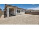 Unlandscaped backyard featuring a covered patio, block wall, and desert surroundings at 105 Barkset Way, Henderson, NV 89011