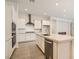 Modern kitchen featuring stainless steel appliances, white cabinetry, and a spacious island at 105 Barkset Way, Henderson, NV 89011