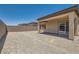 Spacious backyard featuring a covered patio with sliding glass doors and a block wall for privacy at 107 Barkset Way, Henderson, NV 89011