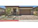Charming single-story home featuring a brick driveway, desert landscaping, and a two-car garage at 107 Barkset Way, Henderson, NV 89011