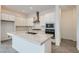 A modern kitchen features quartz countertops, stainless steel appliances, and bright white cabinetry at 107 Barkset Way, Henderson, NV 89011