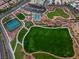Expansive aerial view showcasing community park with walking paths, sports courts, playground, and green spaces at 11289 Vision Peak Ave # 103, Las Vegas, NV 89135
