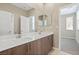 Bathroom with a double sink vanity with modern fixtures, and large mirror at 11289 Vision Peak Ave # 103, Las Vegas, NV 89135