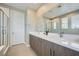 Modern bathroom boasting a double sink vanity, glass-enclosed shower, and bright natural light at 11289 Vision Peak Ave # 103, Las Vegas, NV 89135