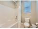 Bright bathroom showcasing a shower-tub combo with white tile and modern fixtures at 11289 Vision Peak Ave # 103, Las Vegas, NV 89135