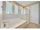 Modern bathroom boasting a soaking tub, glass-enclosed shower, and bright natural light at 11289 Vision Peak Ave # 103, Las Vegas, NV 89135