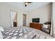 Bedroom with a comfortable bed, dresser, ensuite bath, and reading chair at 11289 Vision Peak Ave # 103, Las Vegas, NV 89135