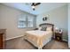 Cozy bedroom features a ceiling fan, a comfortable bed, and natural light from the windows at 11289 Vision Peak Ave # 103, Las Vegas, NV 89135