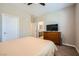 Bedroom with a comfortable bed, dresser, closet and a view to the ensuite bath at 11289 Vision Peak Ave # 103, Las Vegas, NV 89135