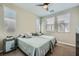 Bright bedroom with two beds, mirrored nightstand, and large windows with blinds at 11289 Vision Peak Ave # 103, Las Vegas, NV 89135