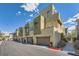 Modern townhome exterior showcasing contemporary architecture, private garages, and well-maintained landscaping at 11289 Vision Peak Ave # 103, Las Vegas, NV 89135