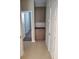 Hallway with built in shelves and cabinets and neutral colored tile floors at 11289 Vision Peak Ave # 103, Las Vegas, NV 89135