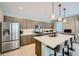 Modern kitchen featuring stainless steel appliances and large island with seating at 11289 Vision Peak Ave # 103, Las Vegas, NV 89135
