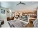 Open concept living room with kitchen and island, sofas and neutral toned rug at 11289 Vision Peak Ave # 103, Las Vegas, NV 89135