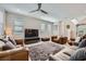 Comfortable living room with plush seating, ceiling fan, and large windows at 11289 Vision Peak Ave # 103, Las Vegas, NV 89135