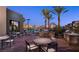 Relaxing outdoor pool area with seating, palm trees, grilling stations, and mountain views at 11289 Vision Peak Ave # 103, Las Vegas, NV 89135