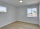 Well-lit bedroom displays wood-look floors and natural light from dual windows at 1225 Arrowhead Ave, Las Vegas, NV 89106