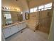 Bright bathroom with double vanity, tub, shower, and tile flooring at 13 Desert Dawn Ln, Henderson, NV 89074