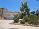 Inviting single-story home showcasing a two-car garage and low-maintenance front yard at 13 Desert Dawn Ln, Henderson, NV 89074