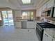 Modern kitchen featuring white cabinetry, granite countertops, and stainless steel appliances at 13 Desert Dawn Ln, Henderson, NV 89074