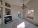 Cozy living room featuring a stylish fireplace, high ceilings, and tile floors at 13 Desert Dawn Ln, Henderson, NV 89074