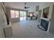 Open-concept living room features tile floors, a fireplace, and sliding glass doors to the backyard at 13 Desert Dawn Ln, Henderson, NV 89074
