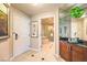 Entryway to the bathroom, showcasing a vanity and walk in shower and jacuzzi tub at 135 E Harmon Ave # 809, Las Vegas, NV 89109
