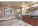 Elegant bathroom with jacuzzi tub, walk-in glass shower and double vanity at 135 E Harmon Ave # 809, Las Vegas, NV 89109
