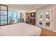 Inviting bedroom suite featuring a kitchenette, comfortable bed, seating area, and stunning city views at 135 E Harmon Ave # 809, Las Vegas, NV 89109