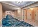 Long hallway boasts stylish carpets and crown molding, creating an inviting path to explore more of the interior at 135 E Harmon Ave # 809, Las Vegas, NV 89109