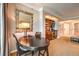 Cozy living area with dark wood dining table, chairs, mirror and kitchenette at 135 E Harmon Ave # 809, Las Vegas, NV 89109