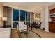 A comfortable living area with modern decor, kitchenette, and expansive city views through large windows at 135 E Harmon Ave # 809, Las Vegas, NV 89109