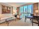 Inviting living room featuring neutral furniture, artwork and expansive windows showcasing the cityscape at 135 E Harmon Ave # 809, Las Vegas, NV 89109