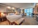 Comfortable main bedroom showcasing the bed, seating area, and incredible city views at 135 E Harmon Ave # 809, Las Vegas, NV 89109
